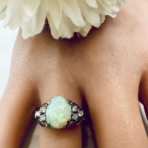 Natural opal ring in platinum settings with real natural diamonds size 6..